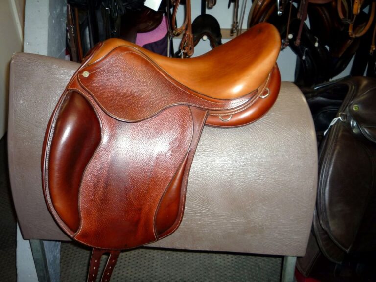 Chestnut leather saddle on a stand in the Newark saddlery