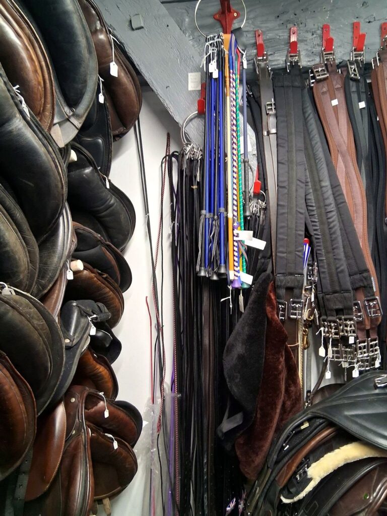 Aisle of used saddles, whips and girths at The Newark Saddler