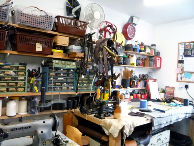 Workbench at The Newark Saddler with bridlework, hand tools and saddlery thread