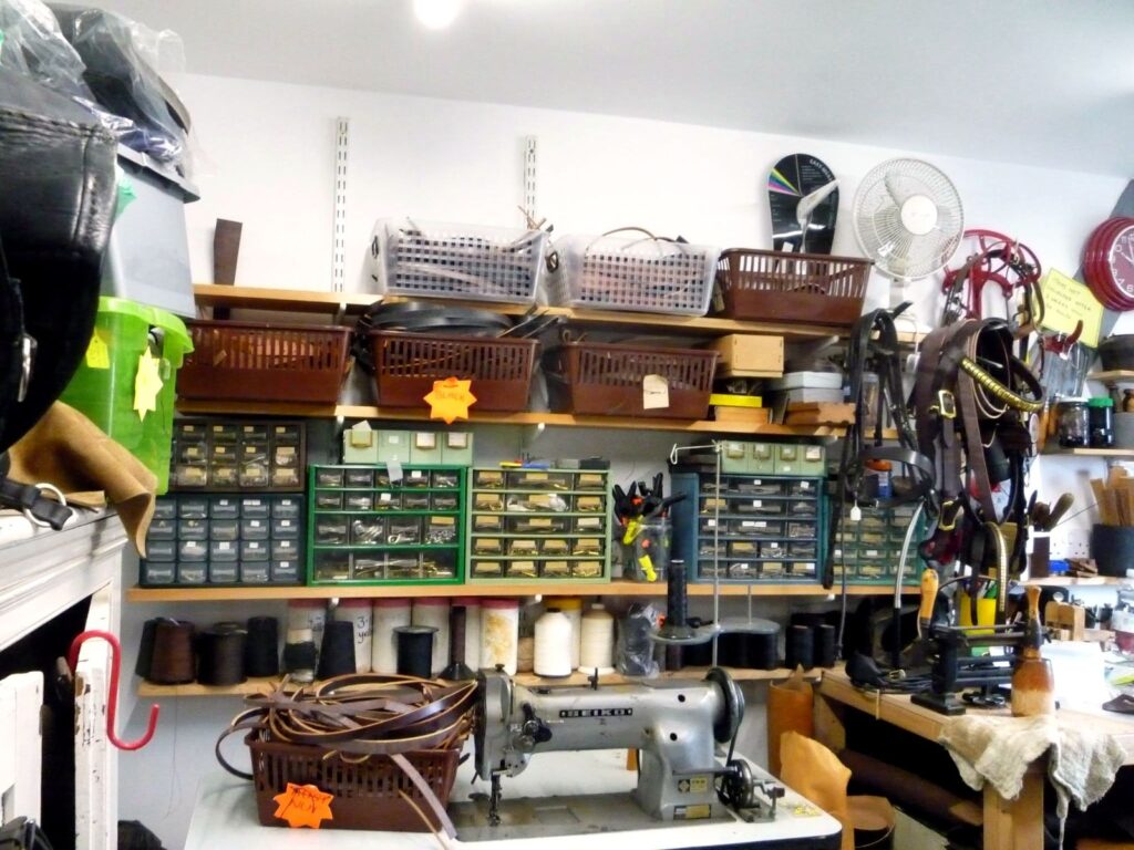 The saddlery workshop at The Newark Saddler, with an industrial leather sewing machine and parts drawers